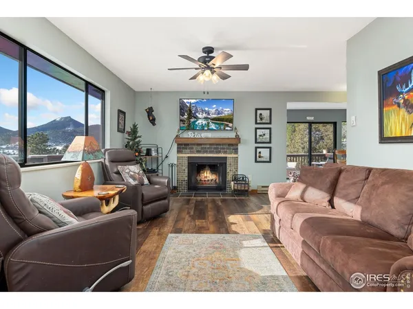 a living room with furniture a fireplace and a large window