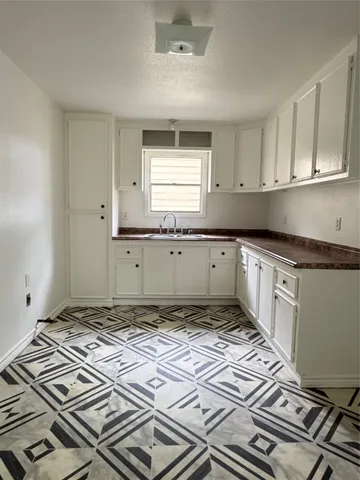 a kitchen with a stove top oven a sink and dishwasher
