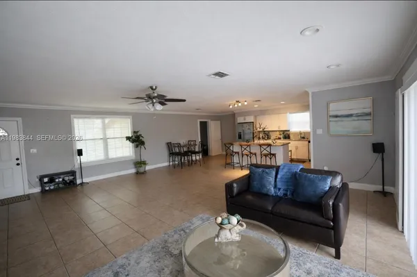 a living room with furniture and a chandelier
