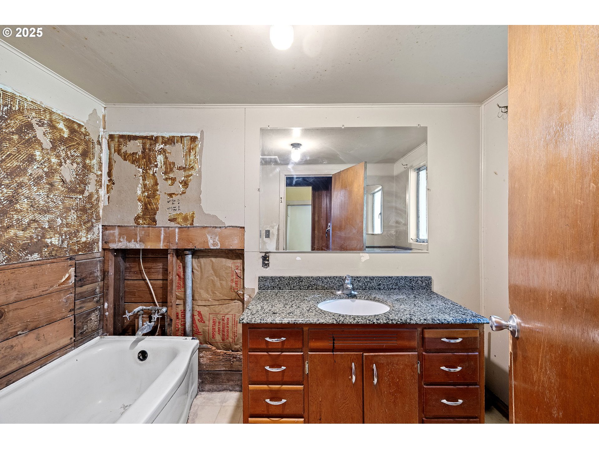 88144 4th Street Veneta, OR 97487 - Photo 14 of 21 a bathroom with a granite countertop sink a large mirror and a bathtub