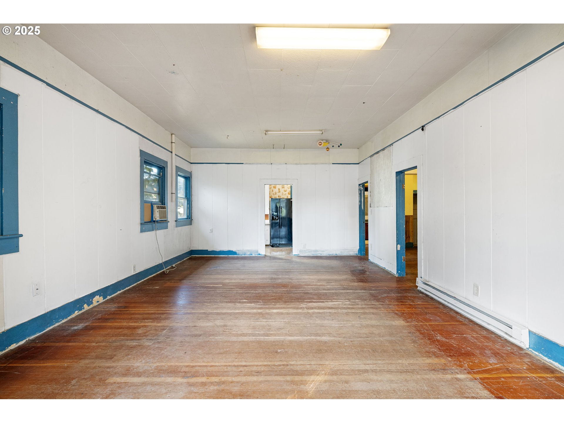 88144 4th Street Veneta, OR 97487 - Photo 5 of 21 a view of an empty room with wooden floor and a window
