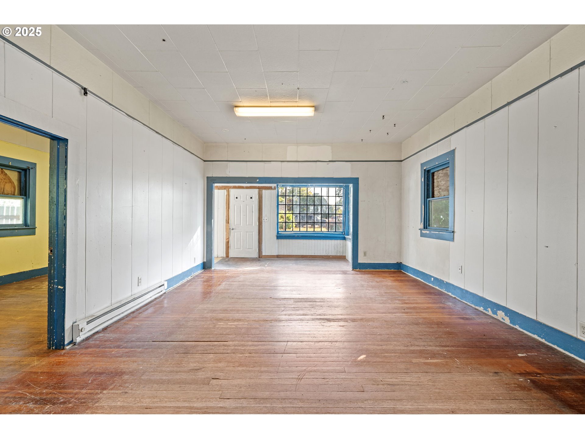 88144 4th Street Veneta, OR 97487 - Photo 7 of 21 a view of an empty room with a window and wooden floor