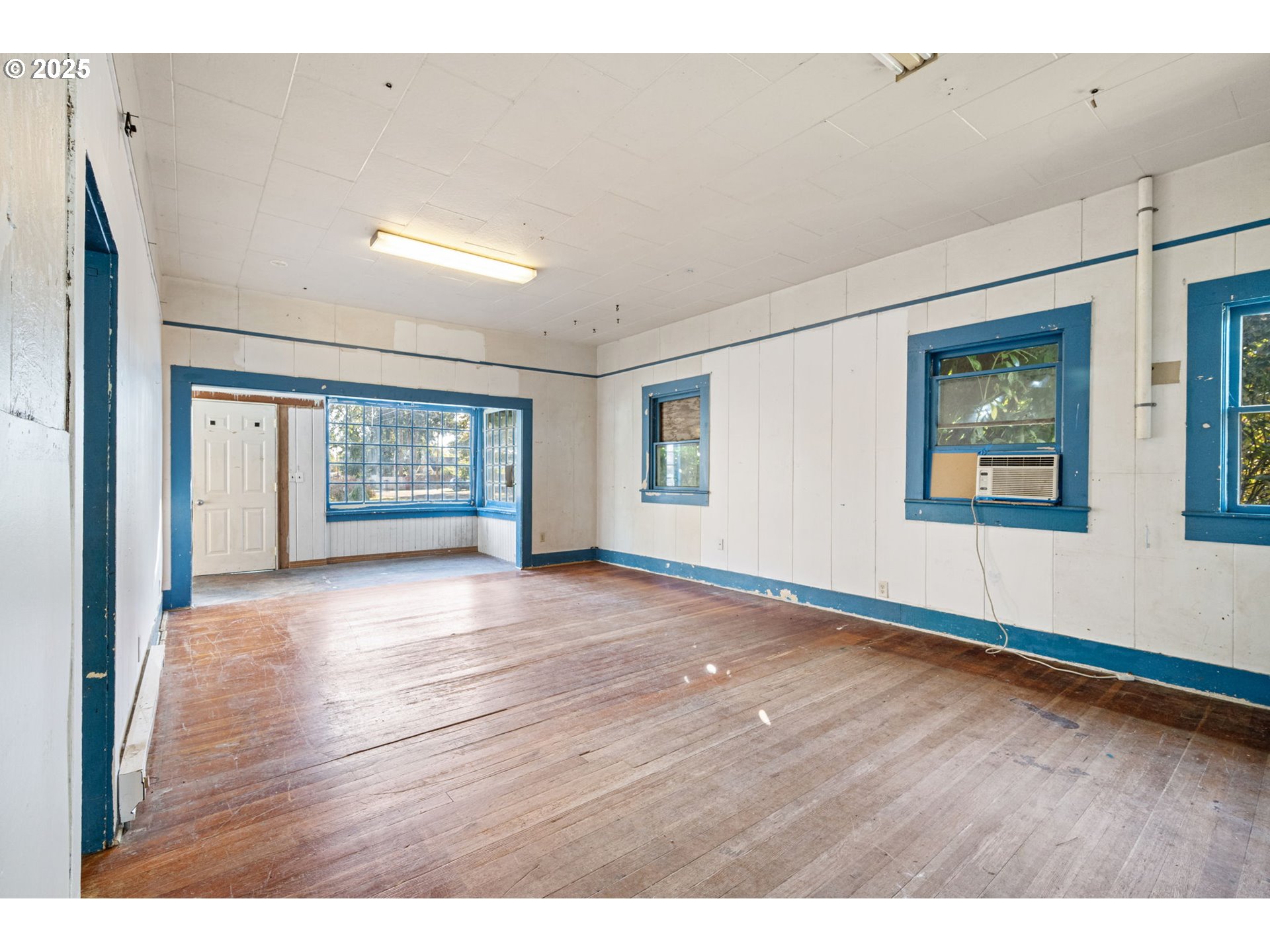 88144 4th Street Veneta, OR 97487 - Photo 9 of 21 a view of an empty room with a window and wooden floor