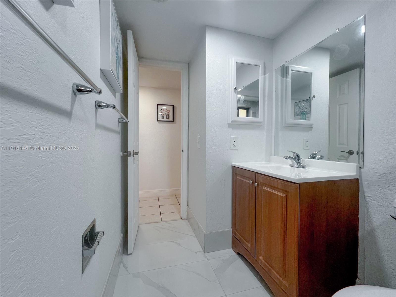 8600 Southwest 133rd Avenue Road, Unit 401 Miami, FL 33183 - Photo 11 of 31 a bathroom with a double vanity sink mirror and shower