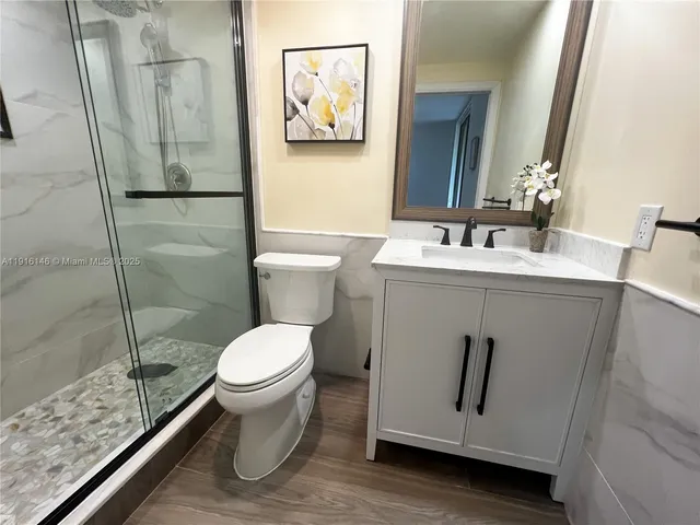a bathroom with a toilet and a shower