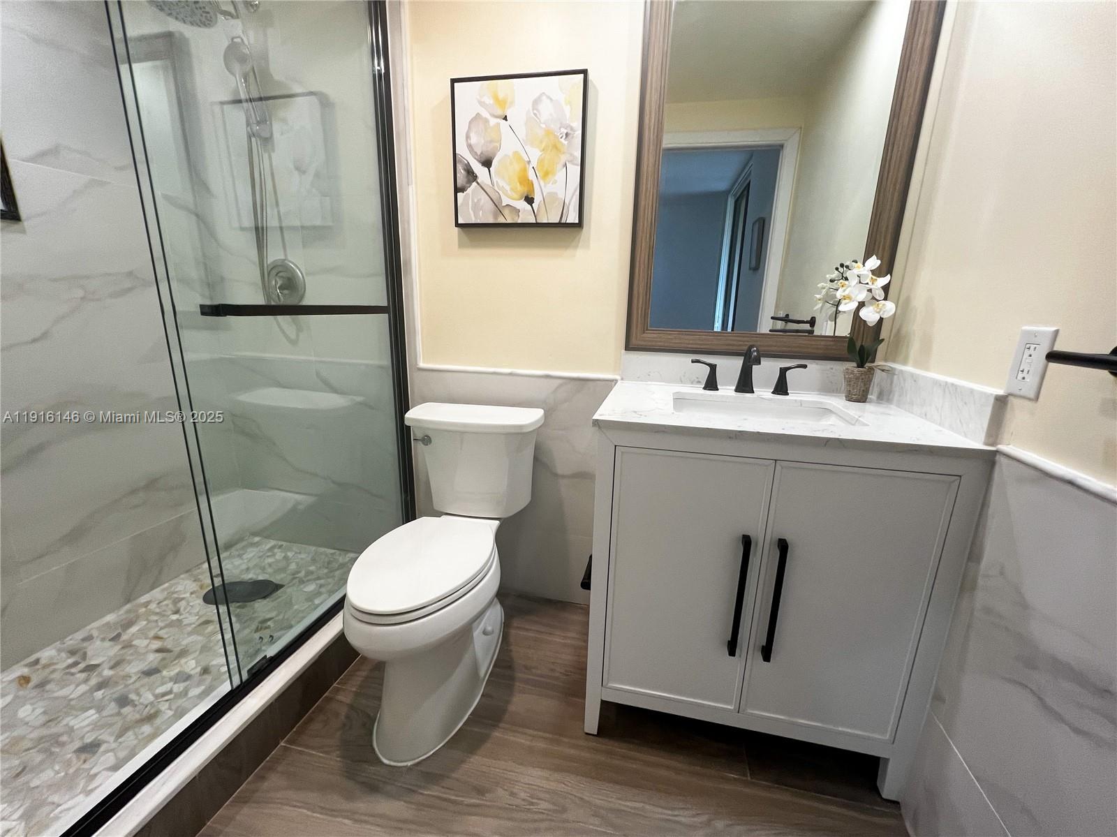 8600 Southwest 133rd Avenue Road, Unit 401 Miami, FL 33183 - Photo 15 of 31 a bathroom with a toilet sink and shower