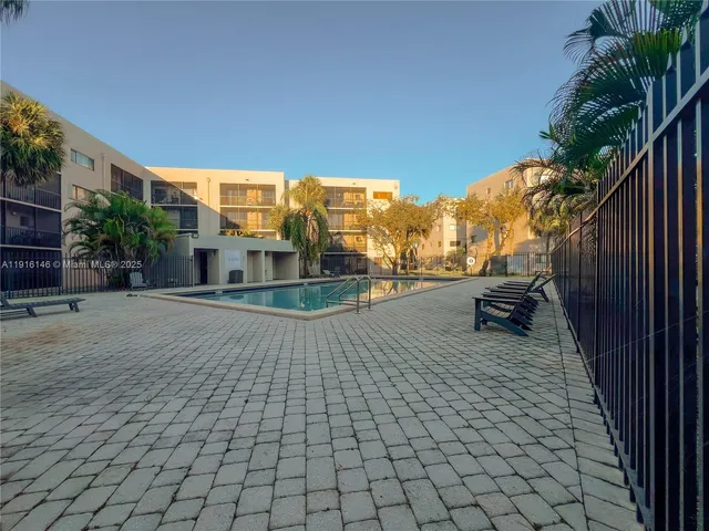 a view of a swimming pool and a yard