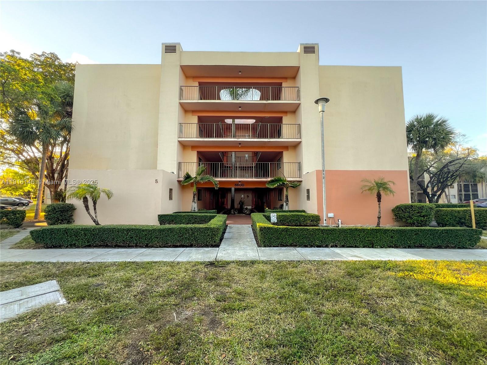 8600 Southwest 133rd Avenue Road, Unit 401 Miami, FL 33183 - Photo 2 of 31 a front view of a house with garden
