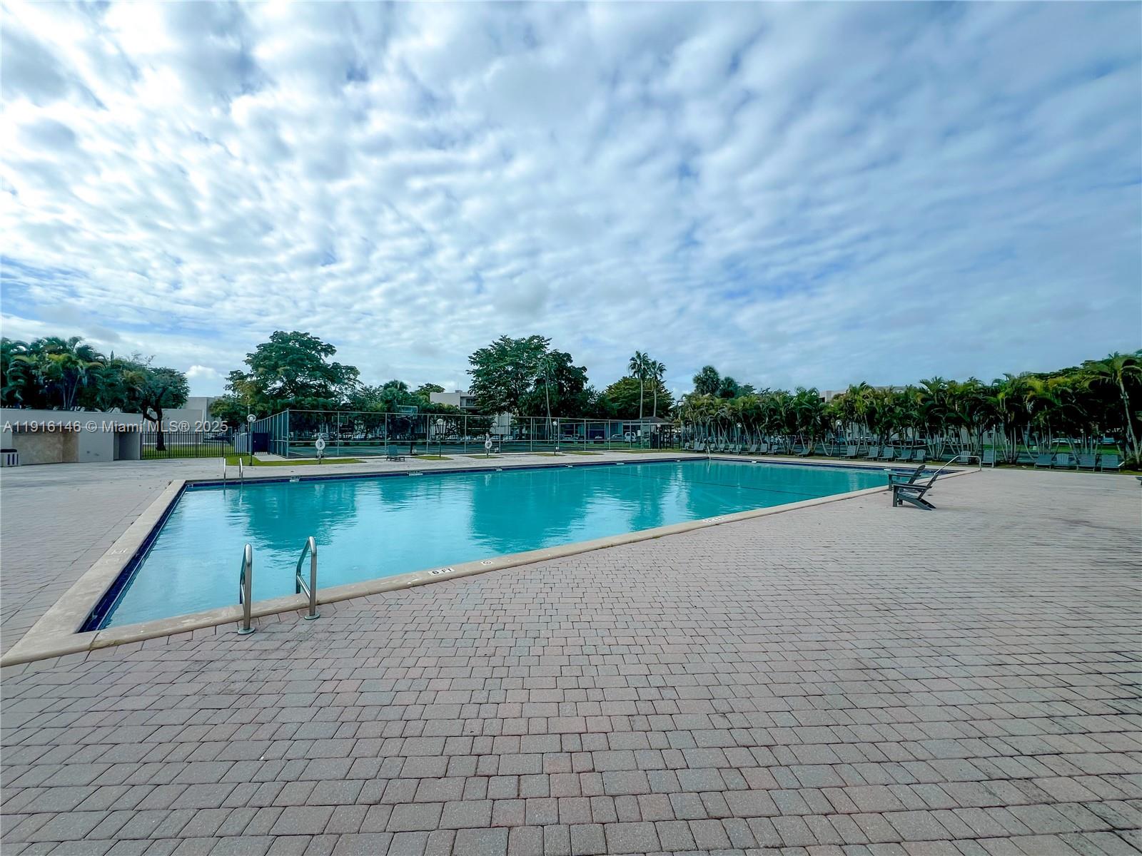 8600 Southwest 133rd Avenue Road, Unit 401 Miami, FL 33183 - Photo 21 of 31 a view of a swimming pool and a yard