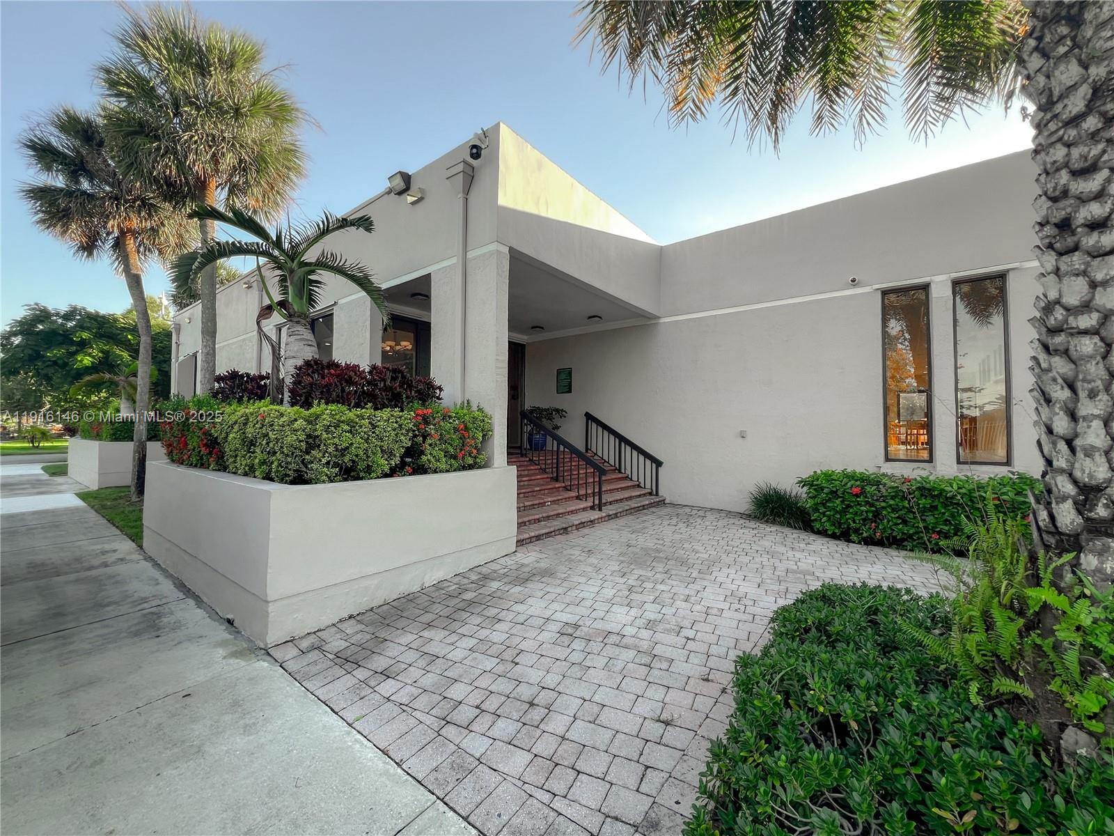 8600 Southwest 133rd Avenue Road, Unit 401 Miami, FL 33183 - Photo 22 of 31 a front view of a house with a yard and a garage