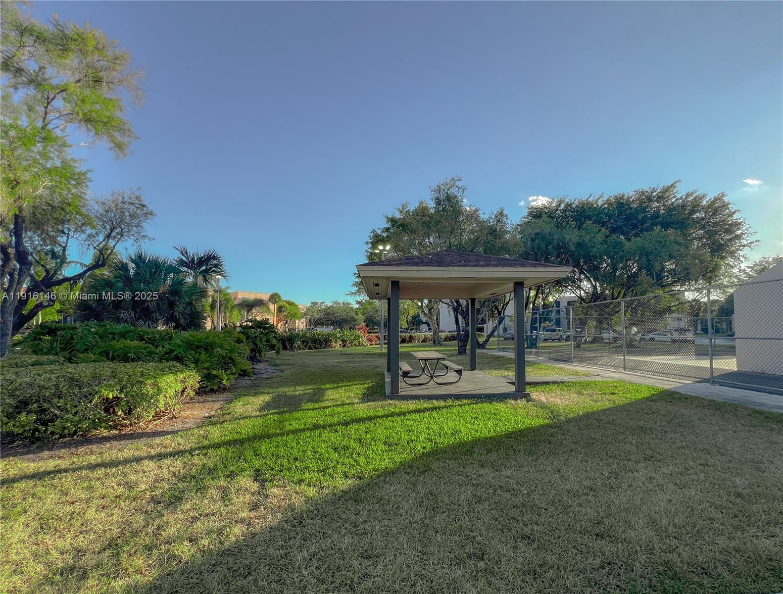 8600 Southwest 133rd Avenue Road, Unit 401 Miami, FL 33183 - Photo 28 of 31 a view of a house with swimming pool and a yard