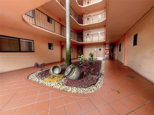 a view of swimming pool with outdoor seating and a garden