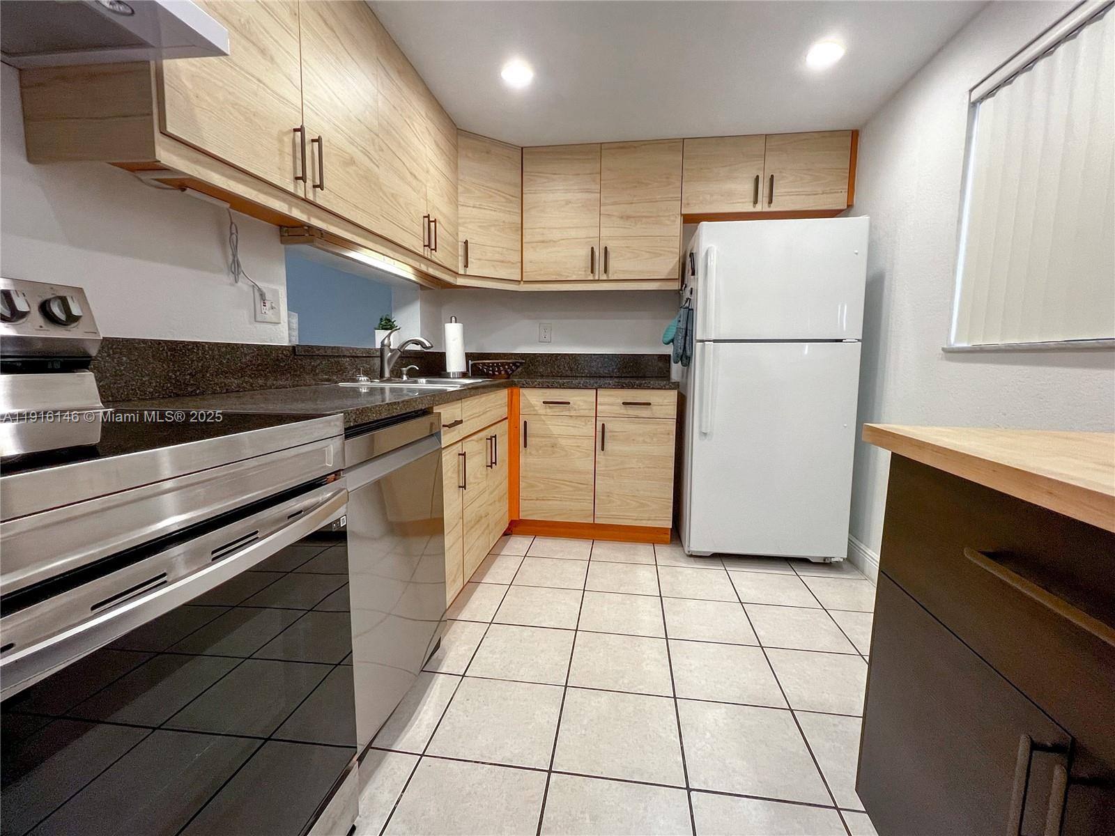 8600 Southwest 133rd Avenue Road, Unit 401 Miami, FL 33183 - Photo 8 of 31 a kitchen with a stove a refrigerator and a sink