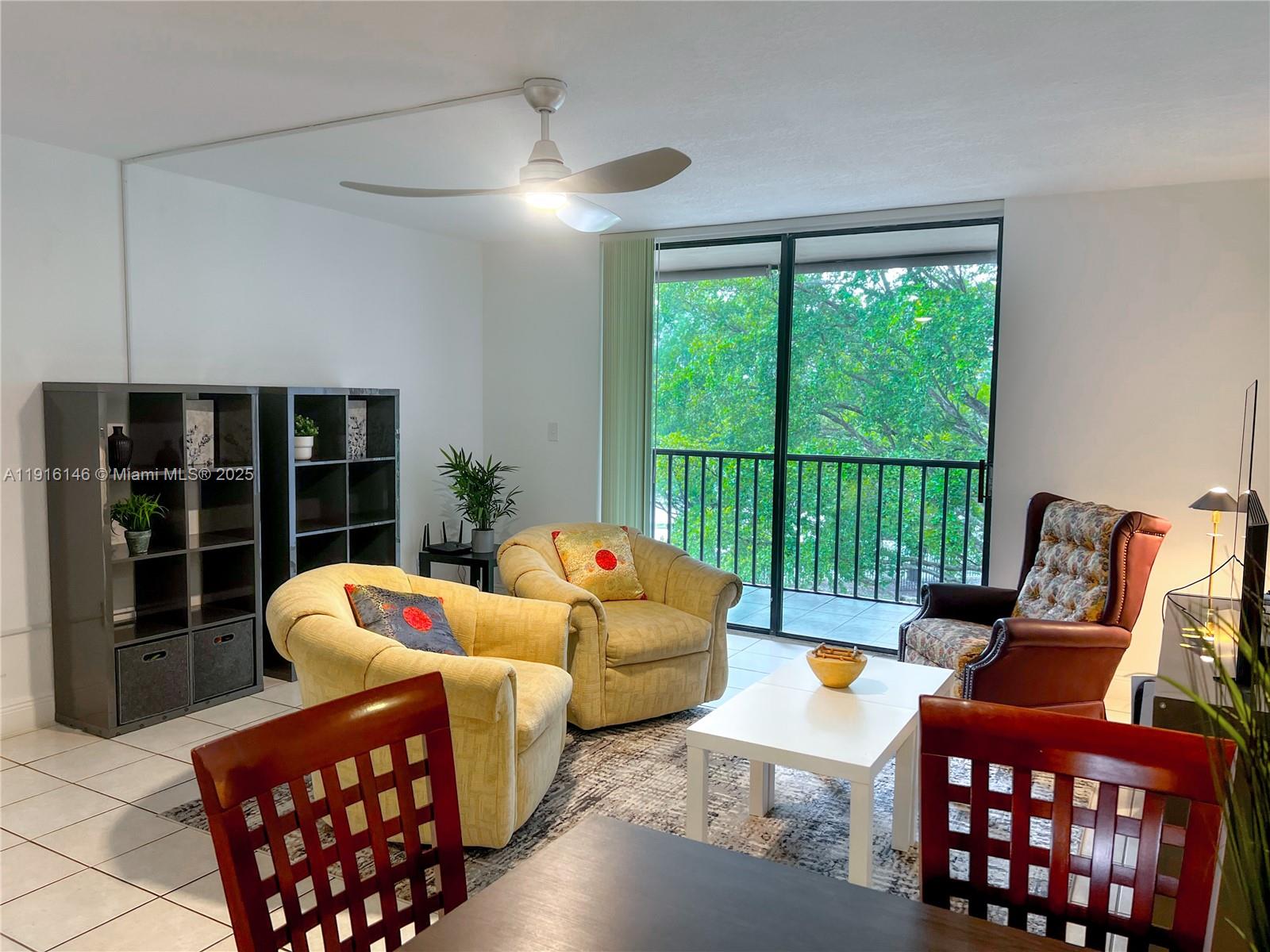 8600 Southwest 133rd Avenue Road, Unit 401 Miami, FL 33183 - Photo 9 of 31 a living room with furniture and a large window