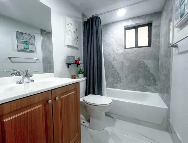 a bathroom with a double vanity sink mirror and shower