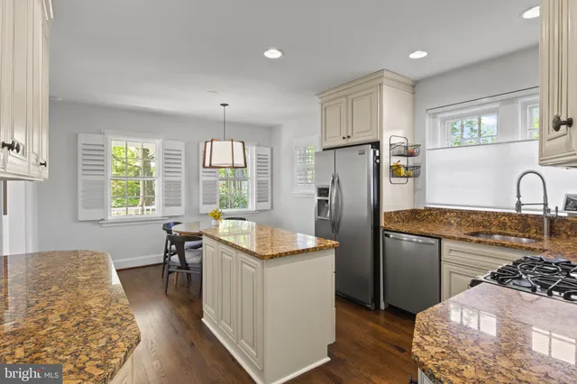 a view of a dining room with furniture a chandelier and wooden floor