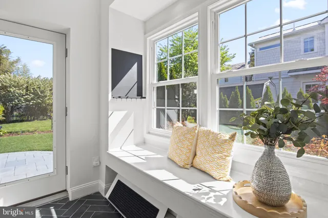 a bedroom with a bed next to a window with wooden floor