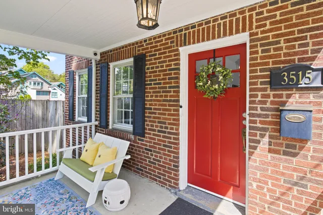 a view of a brick house with a yard and plants