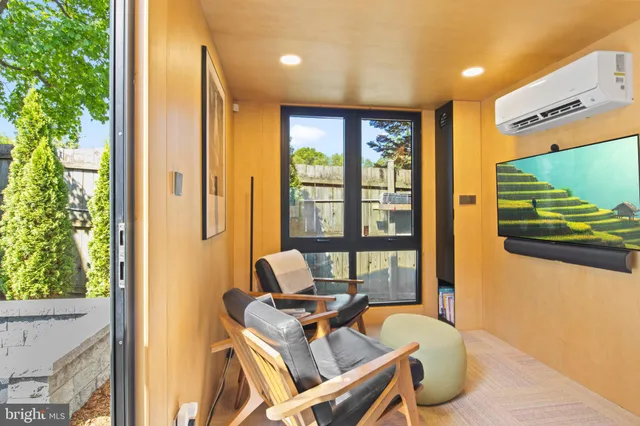a work room with furniture and a flat screen tv