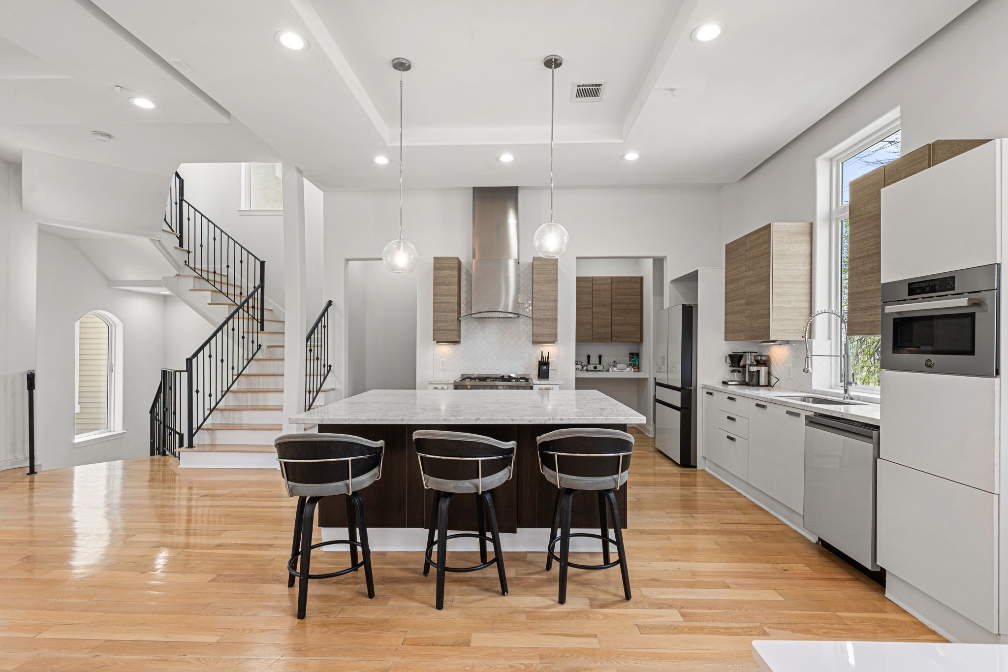 1842 Colquitt Street Houston, TX 77098 - Photo 14 of 42 a kitchen with stainless steel appliances kitchen island granite countertop a table chairs sink and cabinets
