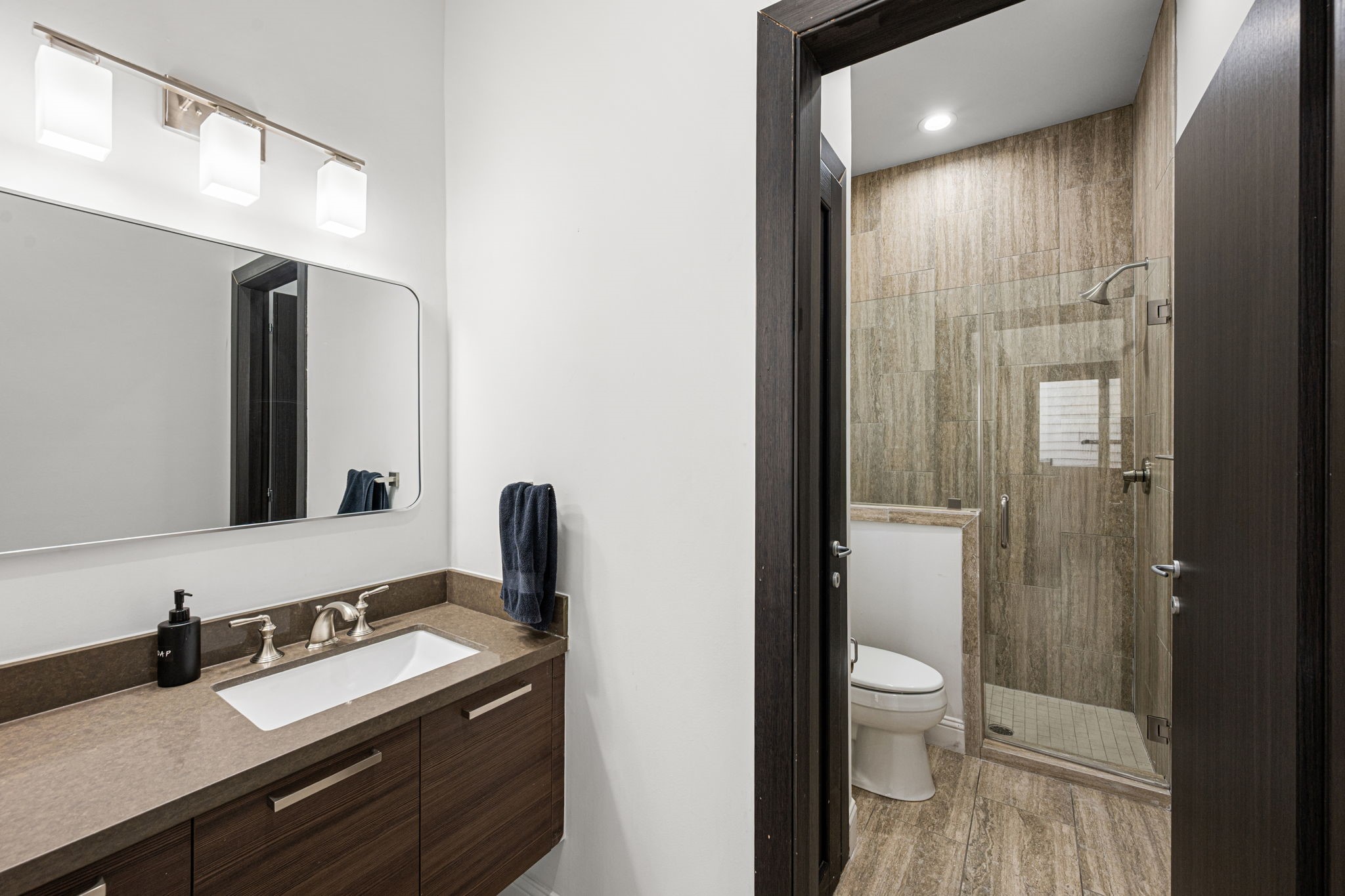 1842 Colquitt Street Houston, TX 77098 - Photo 9 of 42 a bathroom with a granite countertop sink toilet and shower