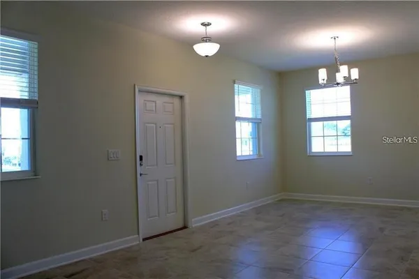 an empty room with closet and windows