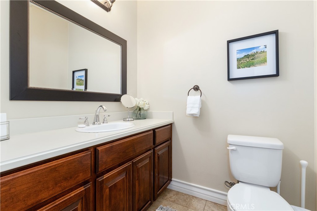669 Red Cloud Road Paso Robles, CA 93446 - Photo 33 of 61 a bathroom with a toilet a sink and mirror
