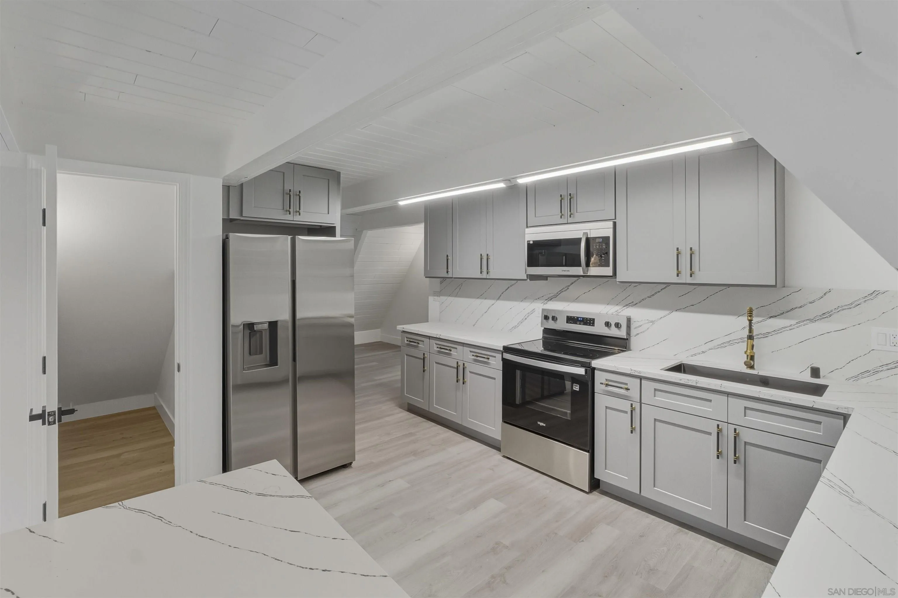 a kitchen with stainless steel appliances granite countertop a refrigerator and a stove top oven