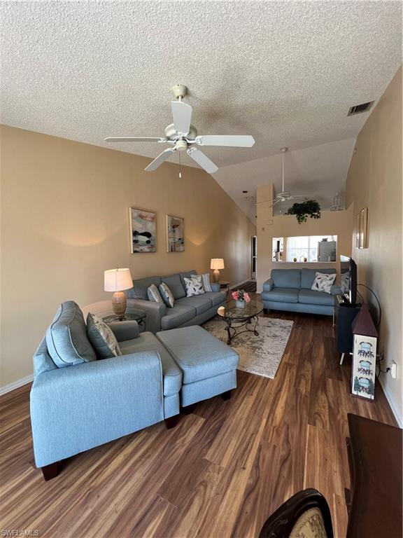185 Grand Oaks Way, Unit R204 Naples, FL 34110 - Photo 3 of 18 a living room with furniture and wooden floor