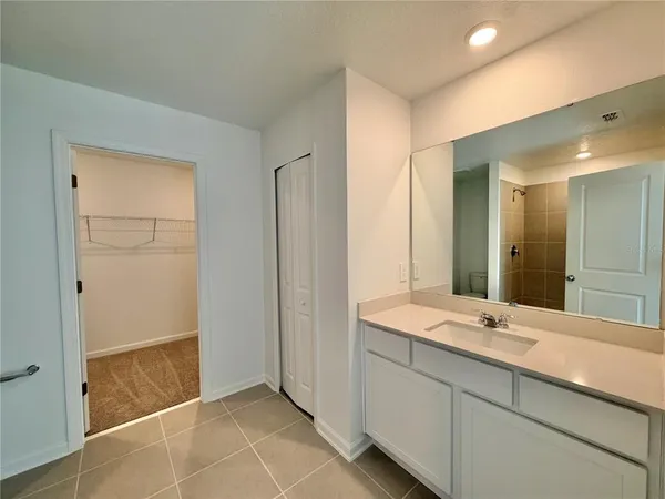 a bathroom with a granite countertop toilet a sink and shower