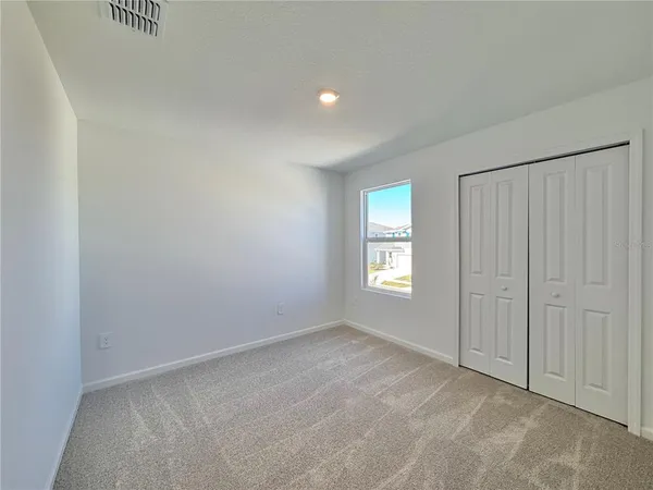 a view of an empty room and a window
