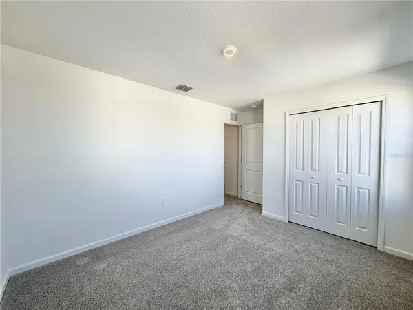 a view of an empty room and a window