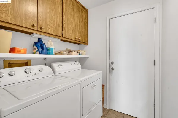 a view of a house with a wooden deck and a yard