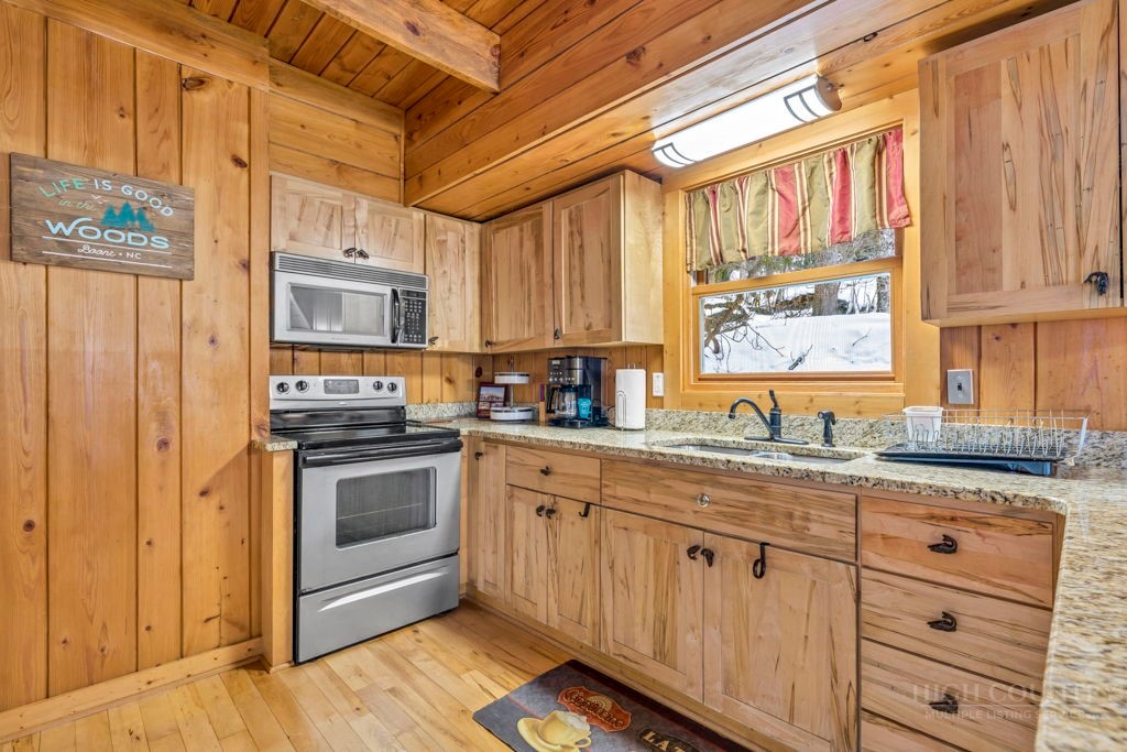 233 Cherry Drive Boone, NC 28607 - Photo 6 of 20 a kitchen with granite countertop a sink cabinets stainless steel appliances and a window