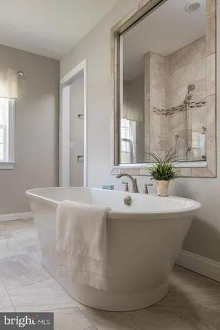 a white bath tub sitting in a bathroom