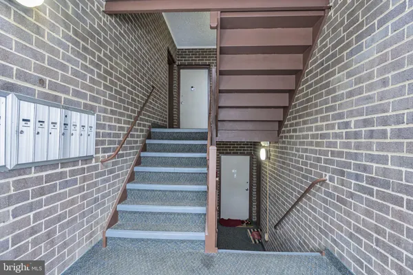 a view of wooden staircase with white walls