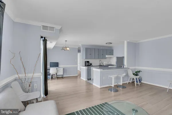 a living room with furniture a rug and white walls