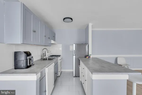 a kitchen with a sink a stove and cabinets