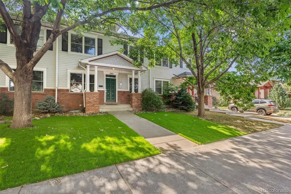 a front view of a house with a garden and yard