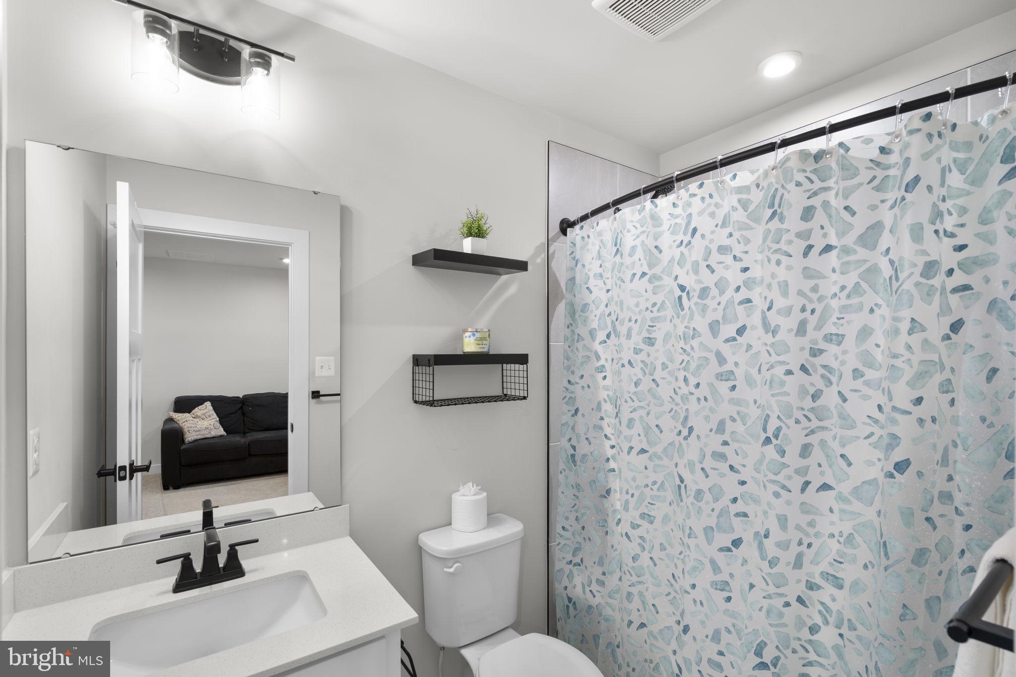1713 Aurora Way Frederick, MD 21702 - Photo 45 of 57 a bathroom with a toilet sink and mirror