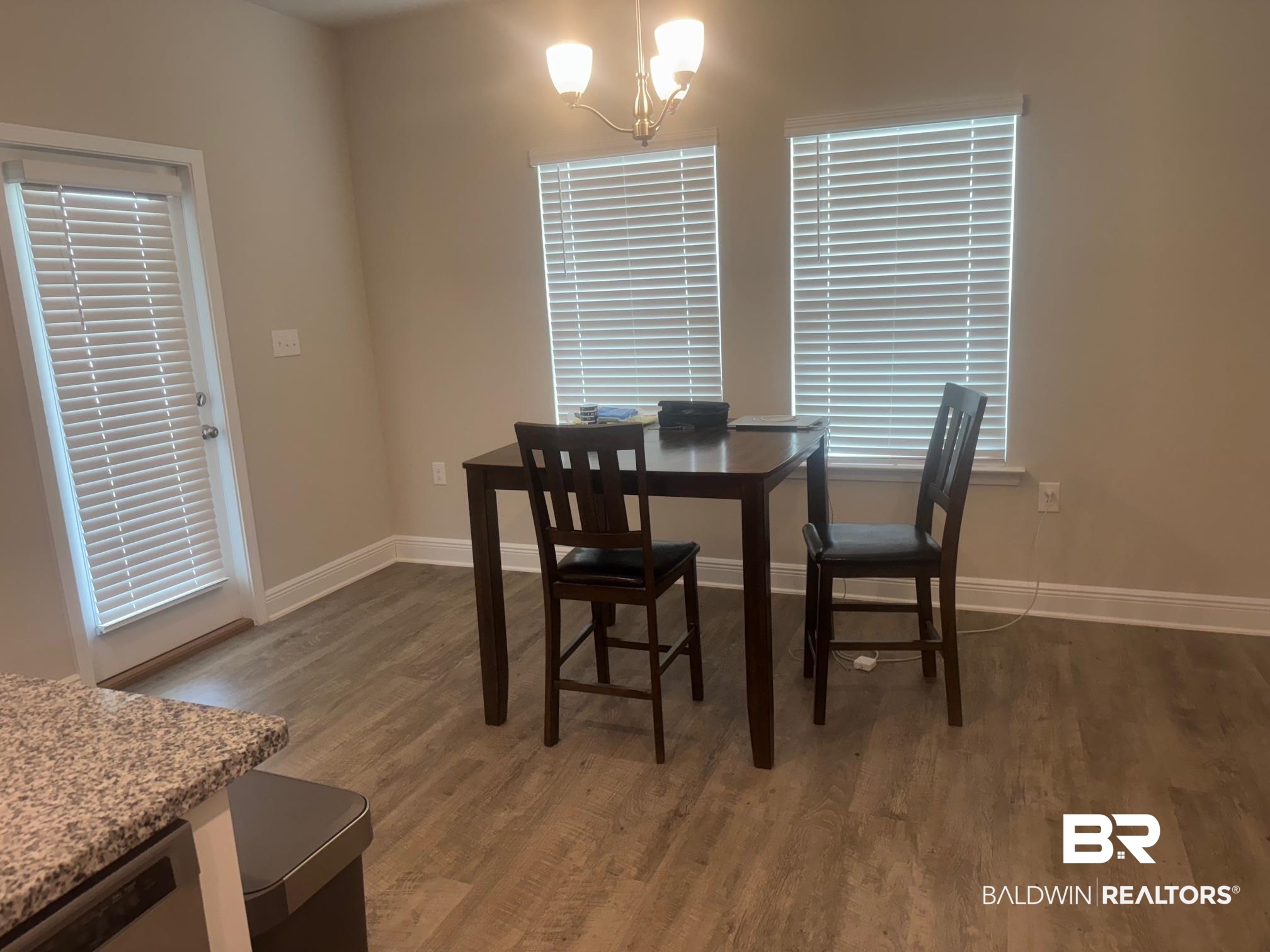 24903 Spectacular Bid Loop Daphne, AL 36526 - Photo 13 of 37 Dining room featuring wood finished floors and a chandelier