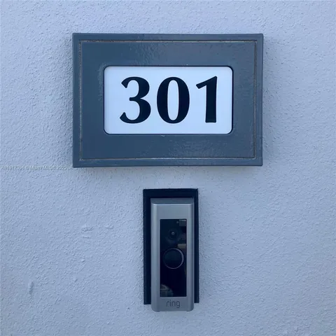 a close up of a sign that is on a wooden wall