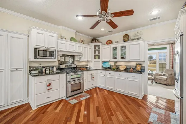 a kitchen with stainless steel appliances granite countertop a stove and a sink