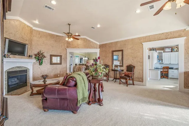 a living room with furniture a fireplace and a flat screen tv