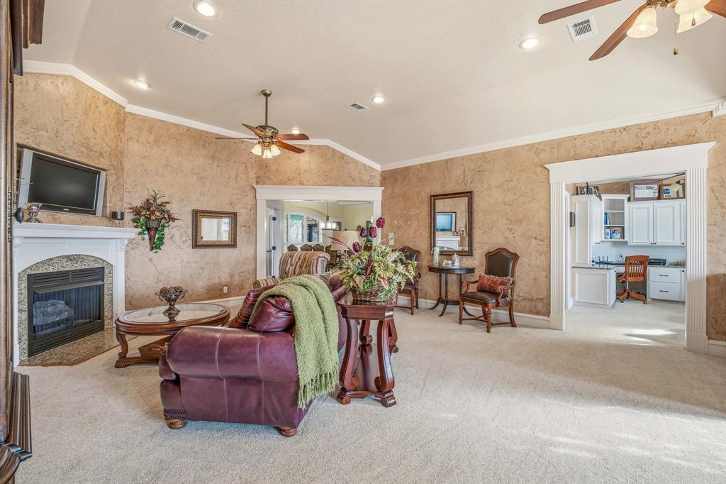 501 County Road 103 Comanche, TX 76442 - Photo 22 of 40 a living room with furniture a flat screen tv and a fireplace