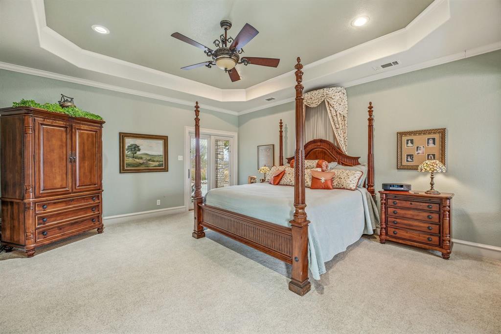 501 County Road 103 Comanche, TX 76442 - Photo 27 of 40 a bedroom with a bed lamp and dresser