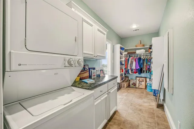 a bedroom with a bed a table and a chandelier