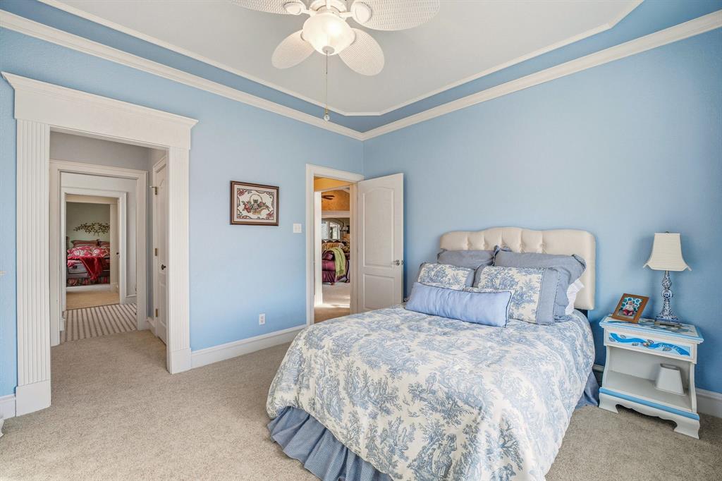 501 County Road 103 Comanche, TX 76442 - Photo 34 of 40 a bedroom with a bed and a chandelier