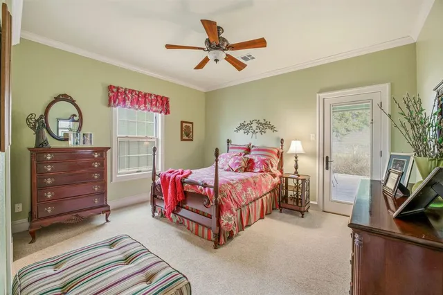 a bedroom with a bed dresser and window