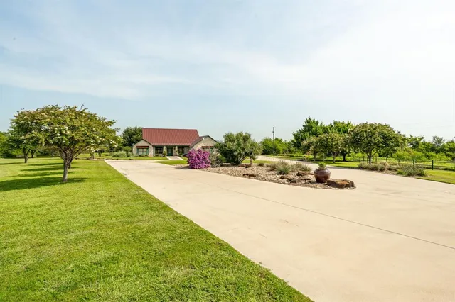 an aerial view of residential houses with outdoor space and street view